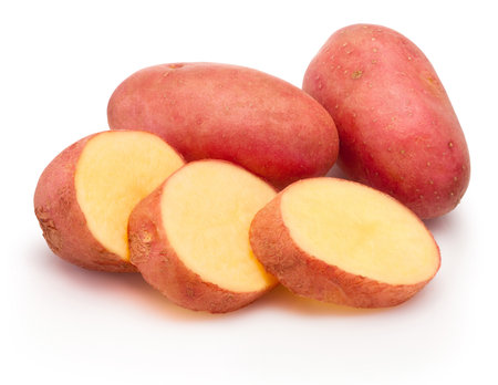 Red potatoes cut in slices isolated on a white backgroundの写真素材