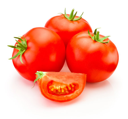 Ripe red tomatoes vegetable with cut isolated on a white backgroundの写真素材