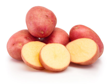 Red potatoes vegetables cut in slices isolated on a white backgroundの写真素材