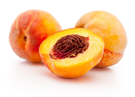 Peaches half and whole isolated on a white backgroundの写真素材
