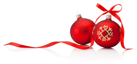 Two red Christmas baubles with ribbon bow isolated on a white backgroundの写真素材
