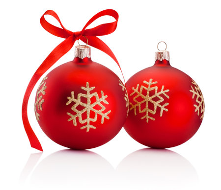 Two red Christmas decoration baubles with ribbon bow isolated on a white backgroundの写真素材