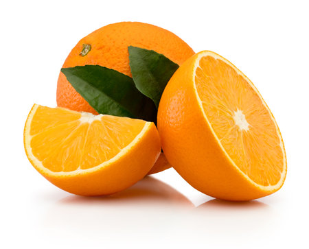 Orange with cut in half and green leaves isolated on a white backgroundの写真素材
