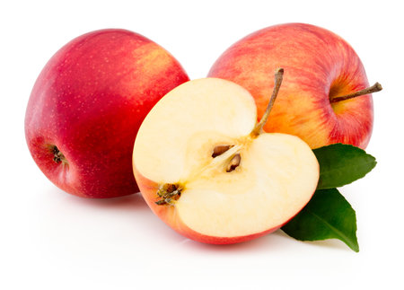 Ripe red apple fruit with cut in half and green leaves isolated on a white backgroundの写真素材