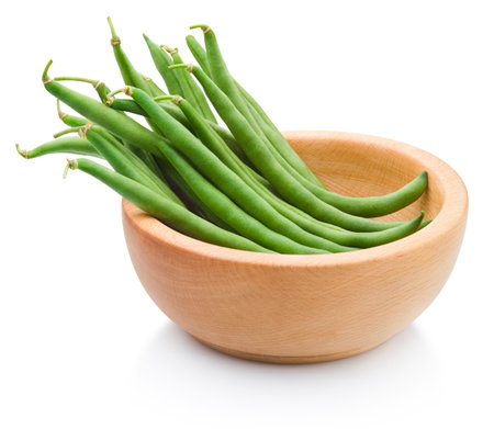 Fresh string green beans in a wooden bowl isolated on a white backgroundの写真素材