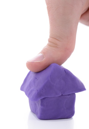thumb crushing house symbol of crashing housing marketの写真素材