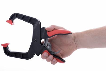 hand holding a clamp isolated on white backgroundの写真素材