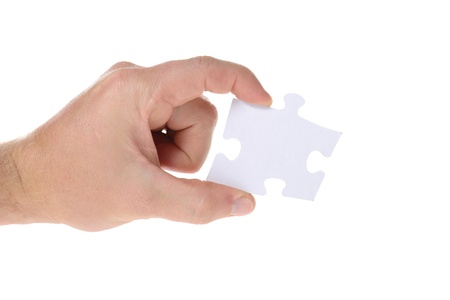 Hand hold a piece of jigsaw puzzle isolated on whiteの写真素材