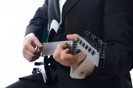 formal man playing guitar isolated on white background の写真素材