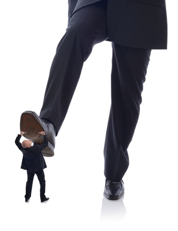 manager Buisnessman in suit stepping on employee isolated on whiteの写真素材