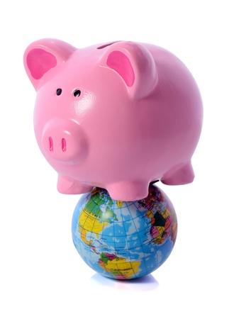 World banking concept, piggy bank on a globe isolated on whiteの写真素材