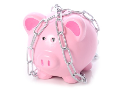 piggy bank wrapped in chains concept of lock out of money or finacial security on white backgroundの写真素材