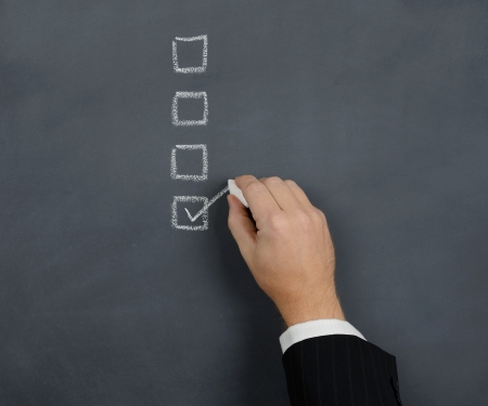 tick in the box on a chalk boardの写真素材