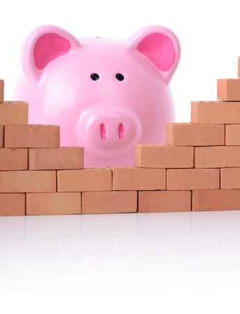 concept piggy bank breaking down the walls of financeの写真素材