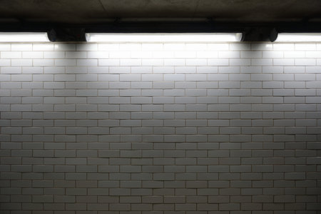 glazed bricks with lights casting shadows from above grunge and dirty lookの写真素材