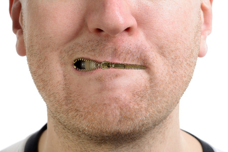 a man being silenced with a zip on the lips isolated の写真素材