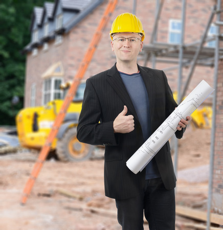 An architect with good news on site of a new homeの写真素材