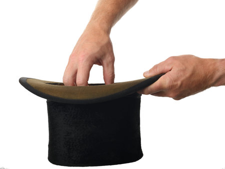 a hand pulling a surpise from the hat isolated on a white background