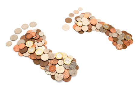 Coins in the shape of feet isolated on white, concept of carbon footprint and fuel costs
