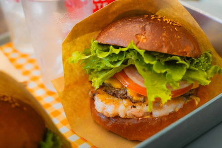 Delicious Handmade Shrimp Burger with Crispy Shrimp Patty and Fresh Vegetablesの写真素材