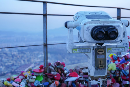 Viewing the Seoul City Panorama Through the Telescope at Namsan Tower Observatoryの写真素材