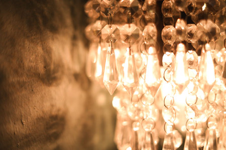 Close-up of a Vintage Chandelier Glowing Under Warm Incandescent Lightsの写真素材