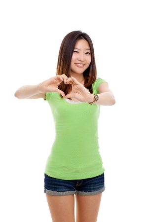 Young Asian pretty woman showing heard shape isolated on white background の写真素材