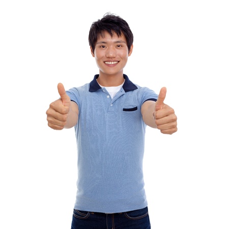 Happy smiling young Asian man show thumb isolated on white background の写真素材