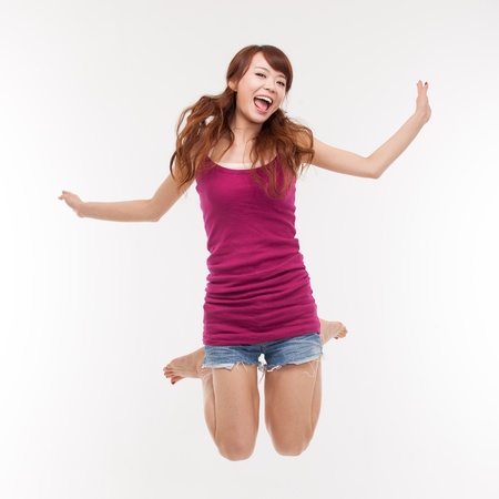 Jumping happy asian womanの写真素材