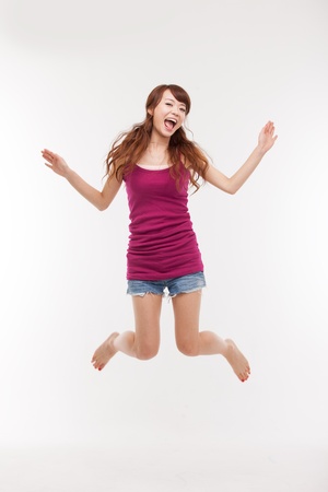 Jumping happy asian womanの写真素材
