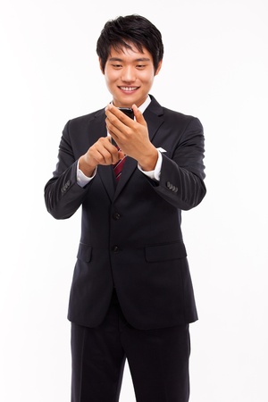 Asian business man with cellphone isolated on white background の写真素材