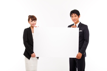 Business couple holding a add banner の写真素材