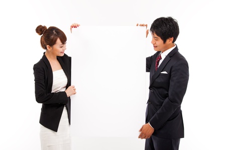 Business couple holding a add banner の写真素材