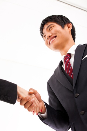Shaking young Asian business man の写真素材