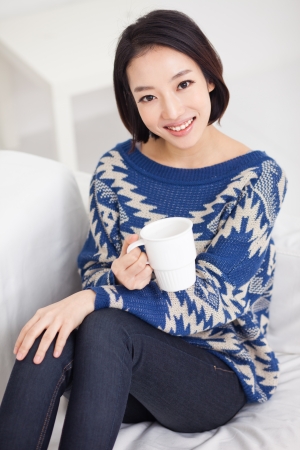 Young Asian pretty woman having a cup of coffee の写真素材