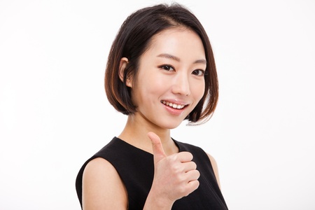 Successful happy Asian businesswoman showing thumb の写真素材