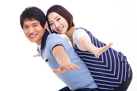 Young man piggybacking his pretty girlfriendの写真素材