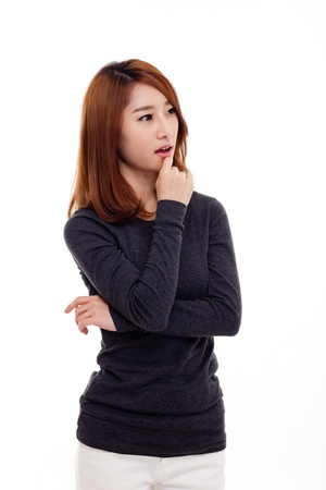 Thinking young Asian woman isolated on white backgroundの写真素材