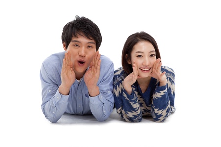 Young Asian couple saying isolated on white background の写真素材