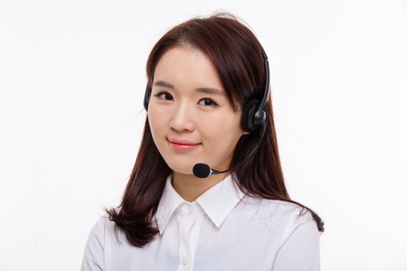 Smiling call center operator business woman isolated on white background  の写真素材