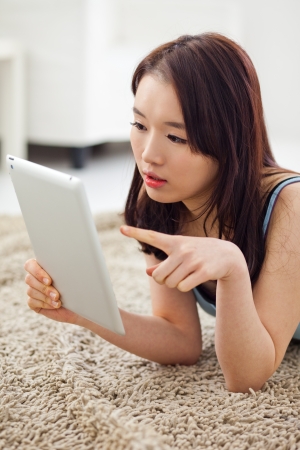 Young Asian woman using a pad PC in the home. の写真素材