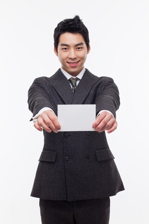Asian young business man with blank card isolated on white background.の写真素材