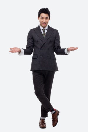 Young Asian business man showing welcom sign isolated on white background.の写真素材