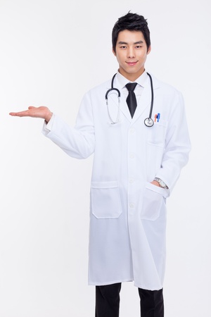 Young Asian doctor present something isolated on white background の写真素材