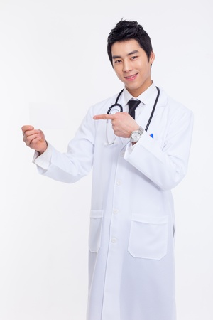 Young Asian doctor showing card isolated on white background.の写真素材