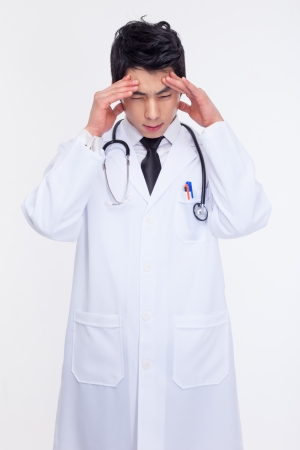 Young Asian doctor having a stress isolated on white background.の写真素材