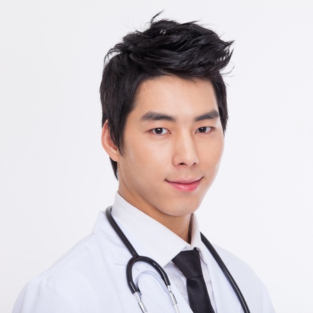 Young Asian doctor close up shot isolate on white background. の写真素材