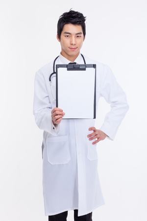 Young Asian doctor showing empty notebook isolated on white background の写真素材