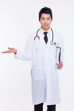 Young Asian doctor present something isolated on white background の写真素材