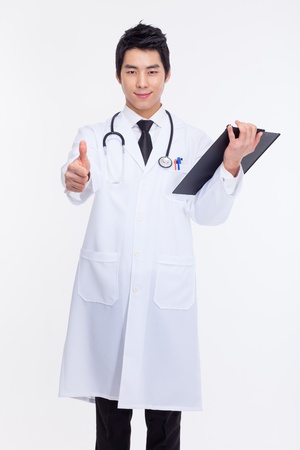 Young Asian doctor showing thumb isolated on white background の写真素材